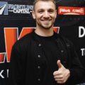 A person in a black shirt showing thumbs up.