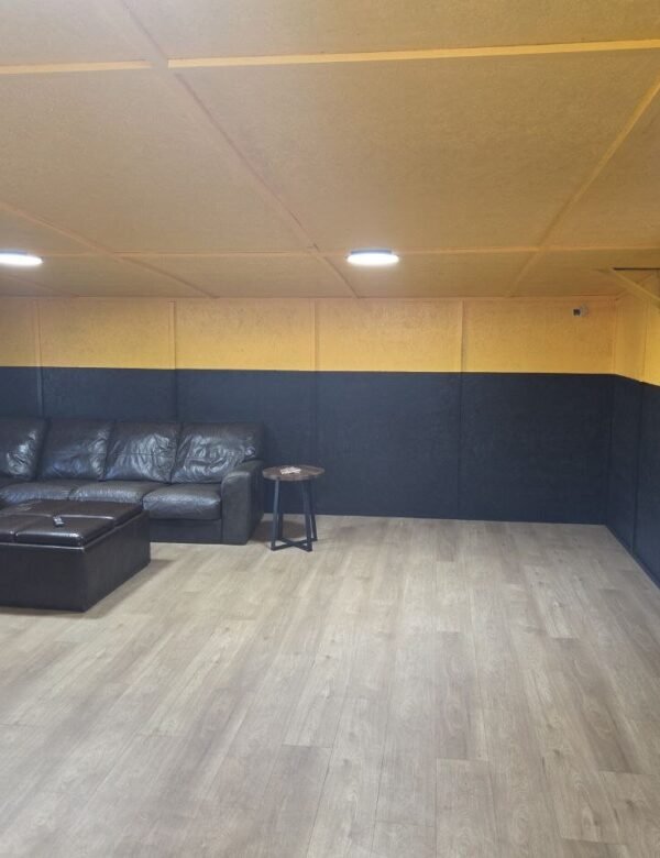 Driver lounge at Truck Pit Stop in Matthews, NC with a leather sectional and wall-mounted TV